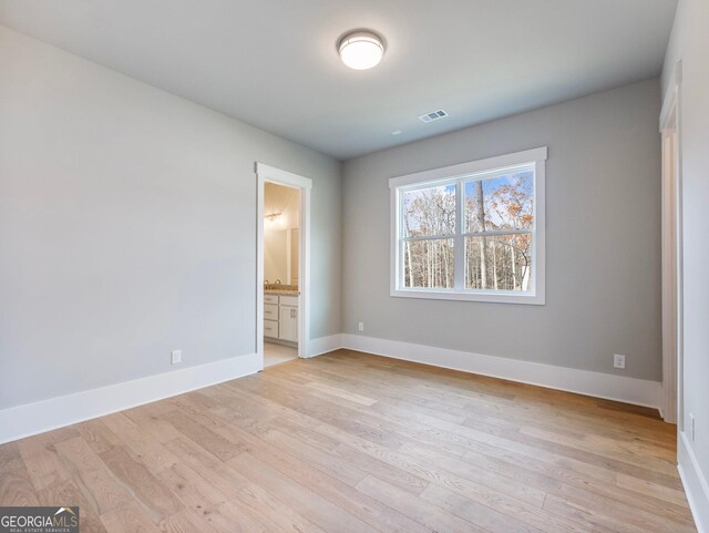 spare room featuring light hardwood / wood-style flooring