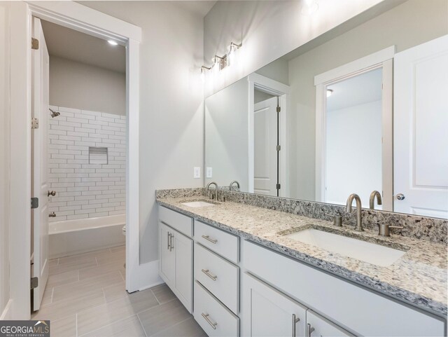 bathroom featuring vanity and tiled shower / bath