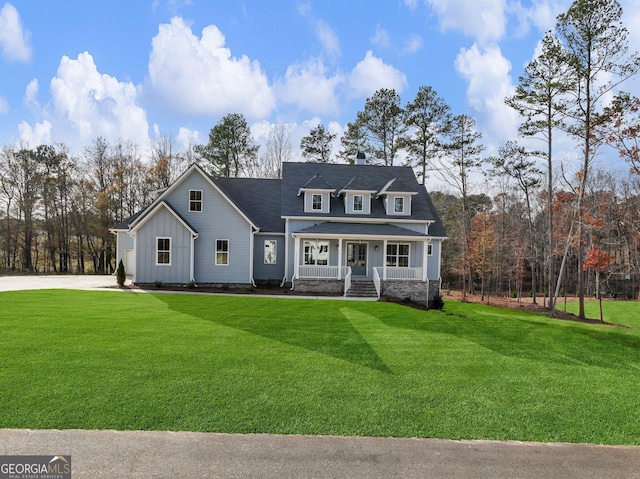 216 Ewing Way, Dacula, GA 30019 - view of front of property featuring board and batten siding, a porch, a front yard, and a chimney
