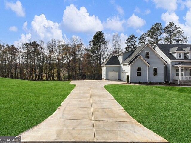 view of front of property with a front lawn and a garage