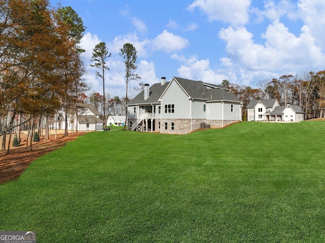 216 Ewing Way, Dacula, GA 30019 - back of house with a yard, a chimney, stairway, and a shingled roof