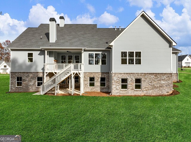 back of house with ceiling fan, a yard, and a deck