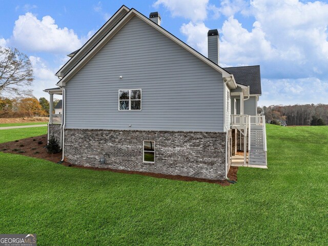 view of side of home featuring a yard