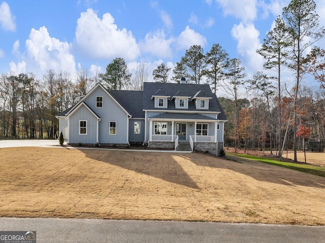 216 Ewing Way, Dacula, GA 30019 - view of front of property with board and batten siding, covered porch, and a chimney