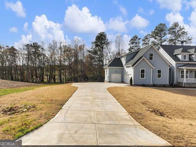 216 Ewing Way, Dacula, GA 30019 - view of front facade featuring board and batten siding, driveway, and a garage
