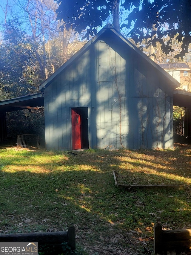 exterior space with an outdoor structure and a yard