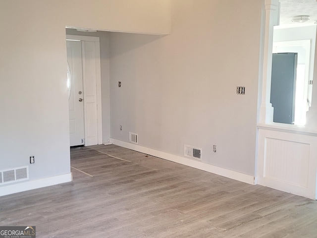 empty room with light hardwood / wood-style flooring