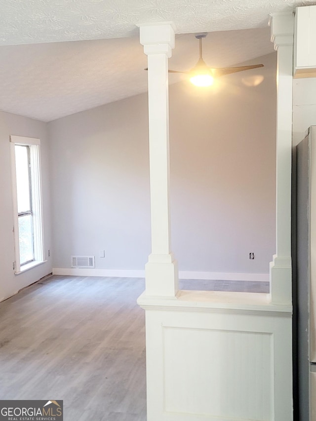 interior space with light hardwood / wood-style floors and a textured ceiling