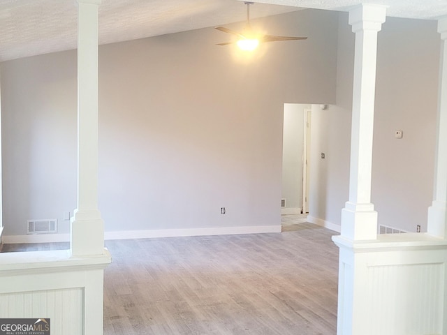 unfurnished living room with a textured ceiling, light hardwood / wood-style floors, and ceiling fan