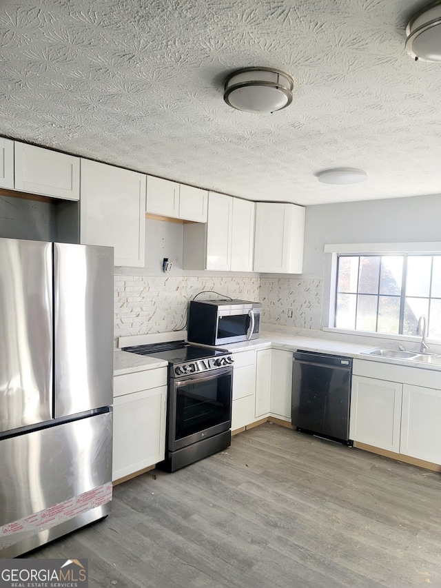 kitchen featuring sink, white cabinets, and appliances with stainless steel finishes