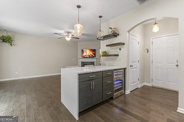 kitchen featuring stainless steel appliances, sink, hanging light fixtures, backsplash, and dark hardwood / wood-style floors