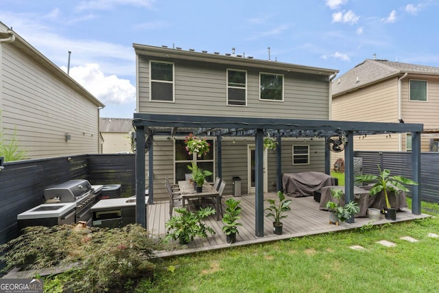 rear view of house with a lawn and a wooden deck