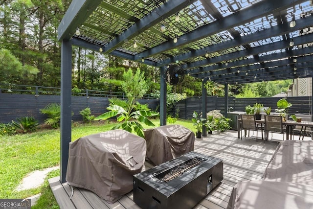 rear view of property with a pergola, a deck, and a lawn