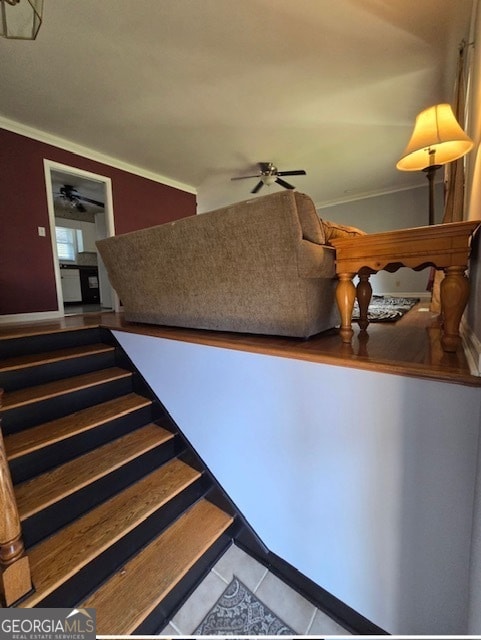 staircase featuring ornamental molding, ceiling fan, and tile patterned floors