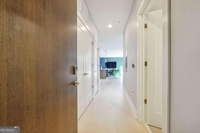 corridor with light wood-type flooring