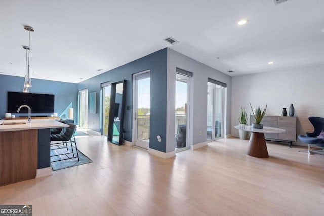 interior space with sink and light hardwood / wood-style flooring