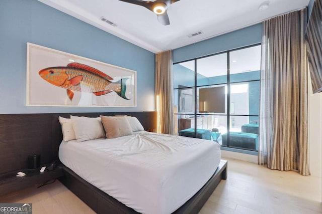 bedroom featuring light wood-type flooring and ceiling fan