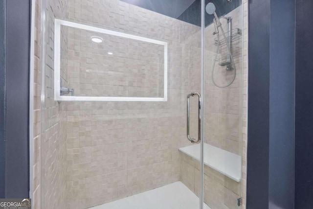 bathroom with a shower with door