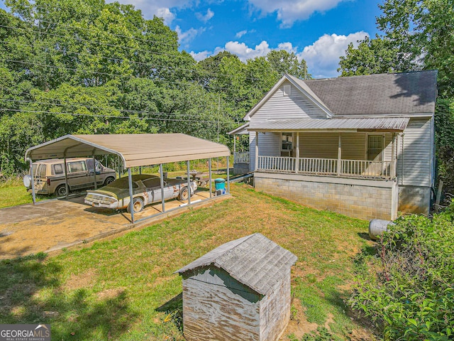 exterior space featuring a porch, a lawn, and a carport