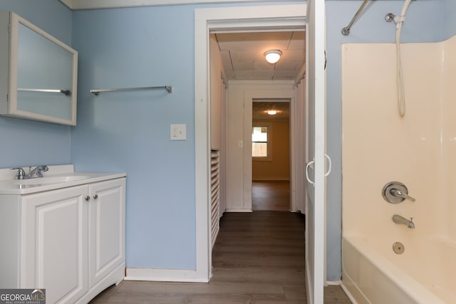 bathroom with shower / bathtub combination, vanity, and hardwood / wood-style flooring