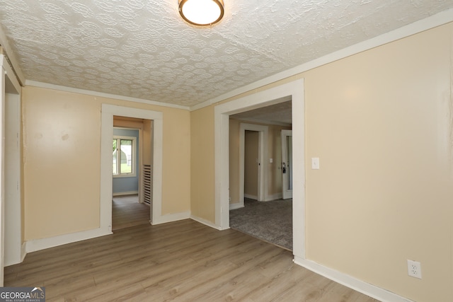 empty room featuring hardwood / wood-style floors and a textured ceiling