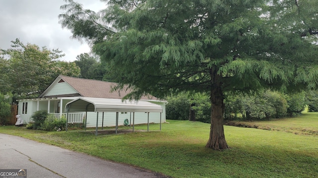 exterior space with a front lawn and a carport