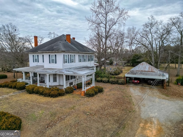 view of home's exterior with a carport and a porch