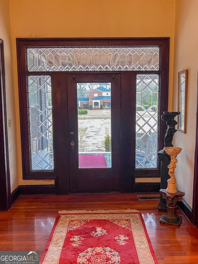 foyer with hardwood / wood-style flooring and french doors