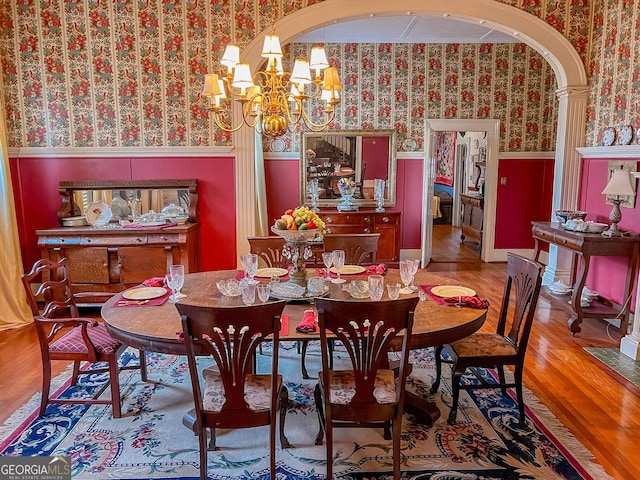 dining room featuring hardwood / wood-style floors and a notable chandelier