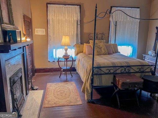 bedroom with dark wood-type flooring