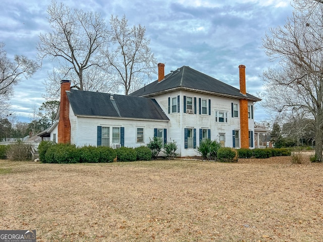 back of house featuring a yard