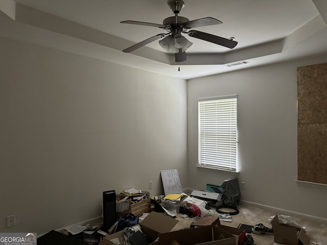 miscellaneous room featuring a tray ceiling, ceiling fan, and carpet