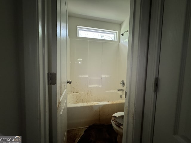 bathroom featuring shower / tub combination and toilet