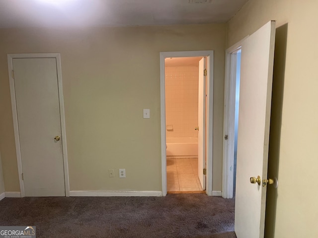 interior space with ensuite bath and carpet floors