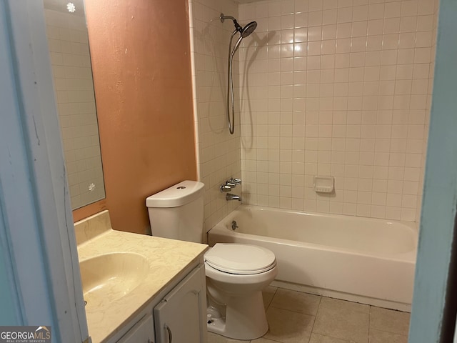 full bathroom featuring vanity, tile patterned flooring, toilet, and tiled shower / bath