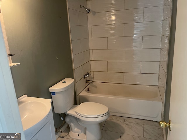 full bathroom featuring tiled shower / bath combo, vanity, and toilet