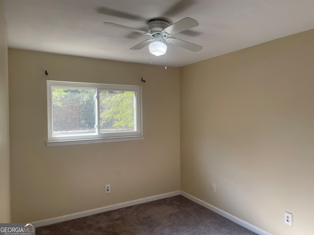 carpeted spare room featuring ceiling fan