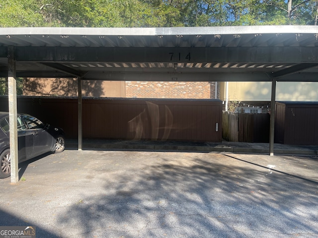 view of parking / parking lot featuring a carport