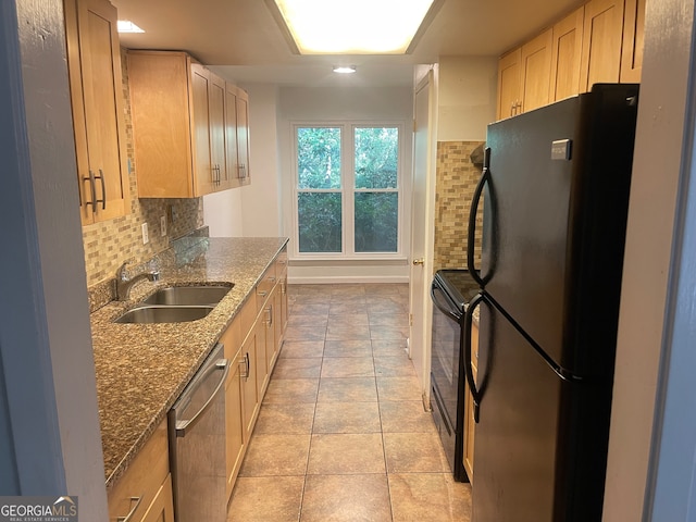 kitchen with light tile patterned floors, sink, backsplash, black appliances, and dark stone counters