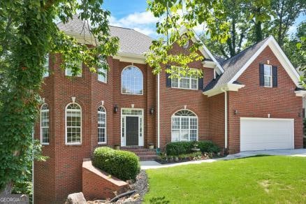 view of front of house with a garage and a front yard