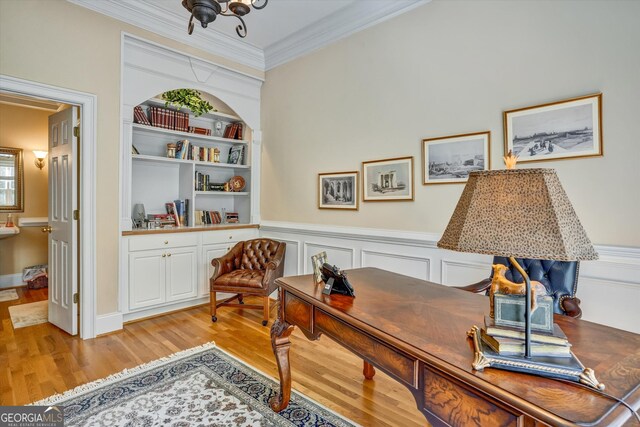 office area featuring light hardwood / wood-style floors and crown molding