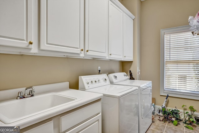 washroom featuring cabinets, independent washer and dryer, a healthy amount of sunlight, and sink