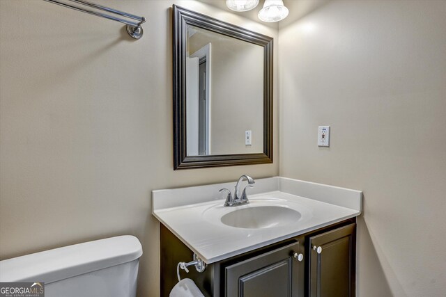 bathroom featuring toilet and vanity