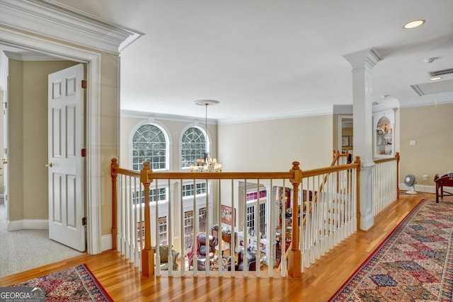 hall with crown molding, a notable chandelier, and light hardwood / wood-style flooring