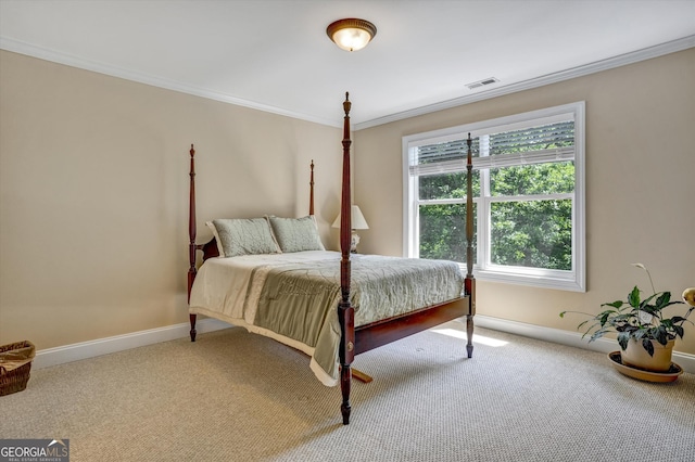 bedroom with carpet flooring and crown molding