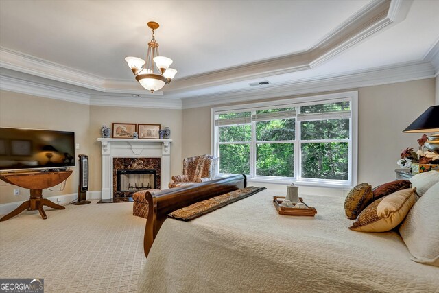 bedroom featuring carpet flooring, ornamental molding, a high end fireplace, and a tray ceiling