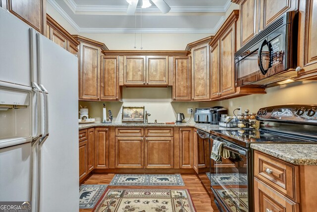 kitchen with sink, light wood-type flooring, ceiling fan, and black appliances