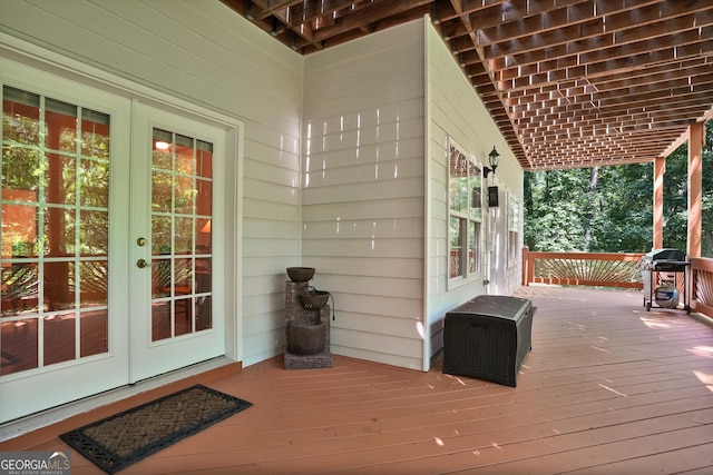 wooden terrace featuring french doors and area for grilling