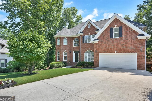 view of front of house featuring a garage and a front lawn