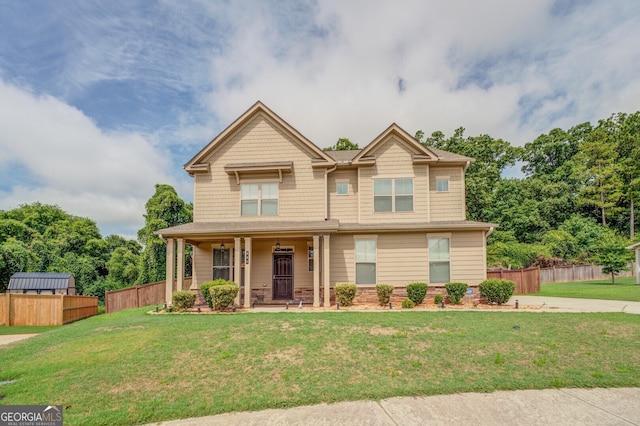 craftsman-style house with a front lawn and covered porch